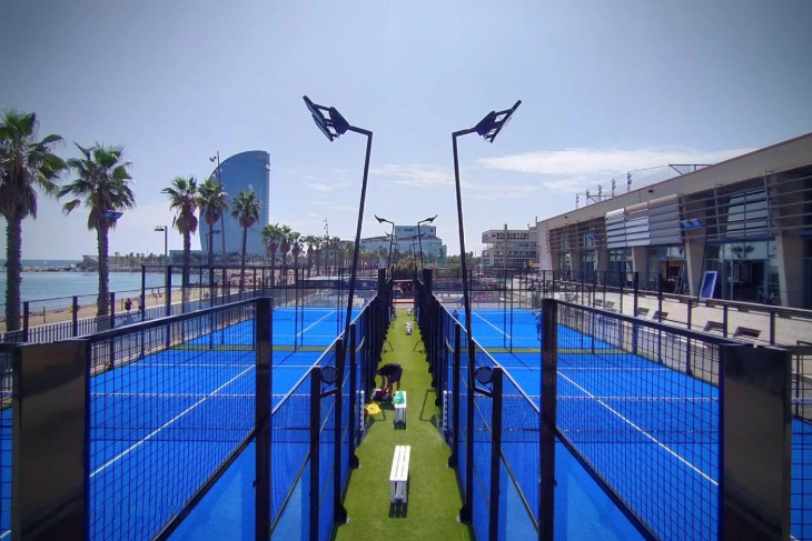 Outdoor and indoor padel courts at a modern club location with players in action.