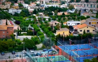 Aerial view of Can Teixidó Pàdel Club with the nearby Maresme village in the background and padel courts in the foreground