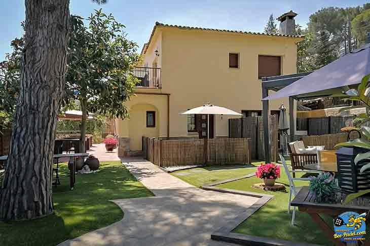 View from the entrance of Villa Cal Music B&B showing the lush garden and two room terraces on the right