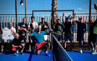 Group of happy Bee-Padel players at CNAB Barceloneta celebrating after an intensive padel session, with Barcelona’s beach in the background
