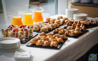 Assortment of fresh croissants and breakfast items laid out on a table at Hotel Atenea Port Mataró