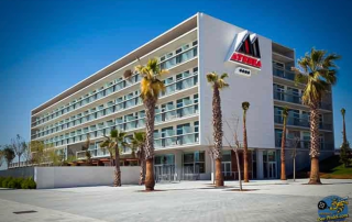 Full side view of the elegant front façade of Hotel Atenea Port Mataró near the beach