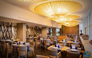 Indoor fine dining restaurant at Hotel Atenea Port Mataró with spacious air-conditioned area connected to terrace
