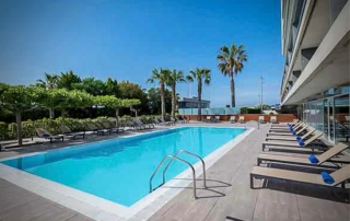 Outdoor swimming pool and sunny terrace of Hotel Atenea Port Mataró near the beach