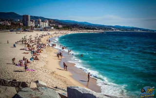 Peaceful beach scene in Mataró with people relaxing under the sun on a clean, uncrowded shoreline near Hotel Atenea Port