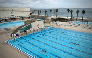 Aerial view of the Olympic outdoor swimming pool at Club Natació Atlètic-Barceloneta, next to the beach in Barcelona.