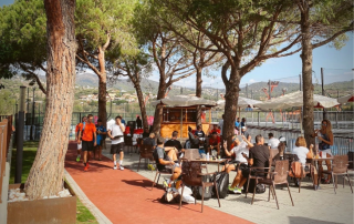 Padel players relaxing and enjoying their time on the terrace beside the courts at Can Teixidó Padel Club