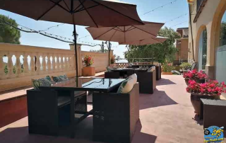 Restaurant terrace at Villa Cal Music B&B with panoramic views over the city below and the Mediterranean Sea