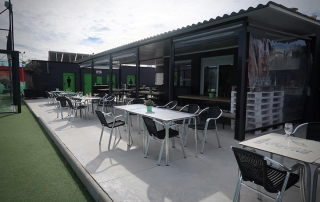 Interior view of Reverse Restaurant looking out towards the terrace at Masnou Ocata Padel Club, Barcelona