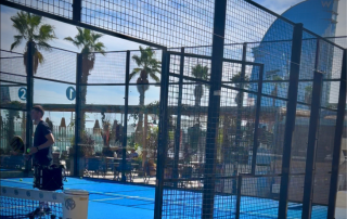 Spain’s top padel trainer Roger Pascual with Bee-Padel players on court at CNAB Barceloneta, with the W Hotel and beach in the background