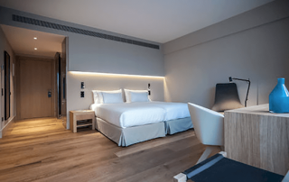 Elegant 4-star hotel room at Sorli Emocions with modern amenities and warm Mediterranean design