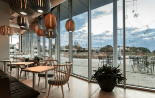 Interior view of the air-conditioned Sorli Emocions Restaurant with elegant dining tables and natural light