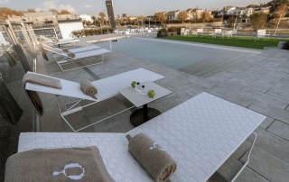 Rooftop terrace at Hotel Sorli Emocions with sunbeds and stunning views of Barcelona and the Mediterranean