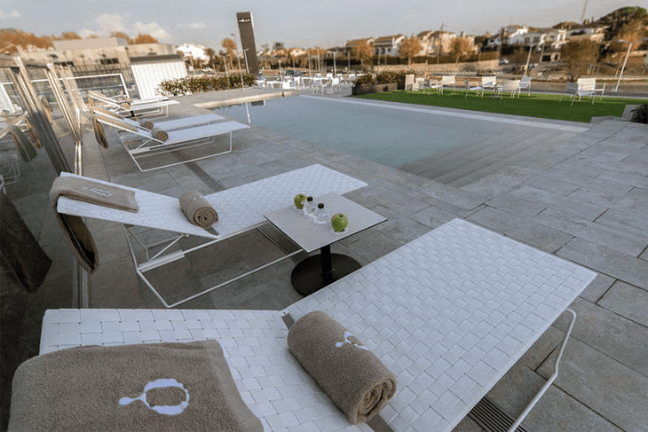 Rooftop terrace at Hotel Sorli Emocions with sunbeds and stunning views of Barcelona and the Mediterranean