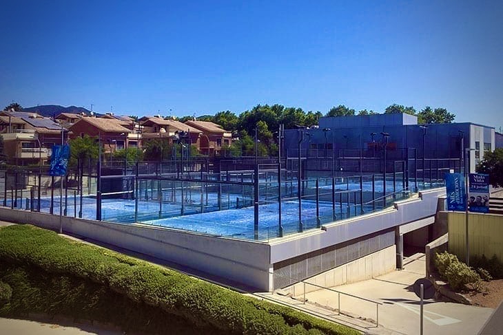 View from the hotel rooftop terrace overlooking all six panoramic padel courts at SorliSport in Vilassar, Barcelona.