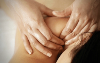 Close-up of massage therapist’s hands applying pressure on a person's back during a wellness session at SorliSport in Vilassar, Barcelona.