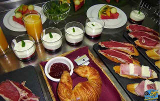 Delicious Spanish breakfast at Villa Cal Music B&B with croissants, fresh fruits, yoghurt, ham, and eggs