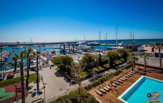 View from hotel room at Atenea Port Mataró overlooking the pool, harbour, and Mediterranean Sea