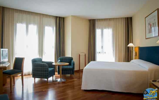 Basic and clean hotel room at URH Ciutat de Mataró with natural light and functional amenities
