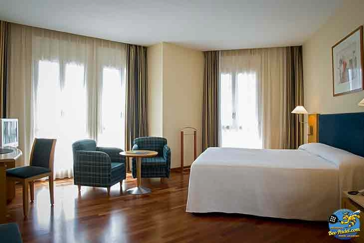 Basic and clean hotel room at URH Ciutat de Mataró with natural light and functional amenities